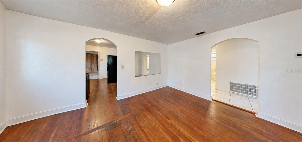 A kitchen features beige cabinets, laminate countertops, a double sink, and a black stove — 415 MODEL STREET, DAYTONA BEACH, FL
