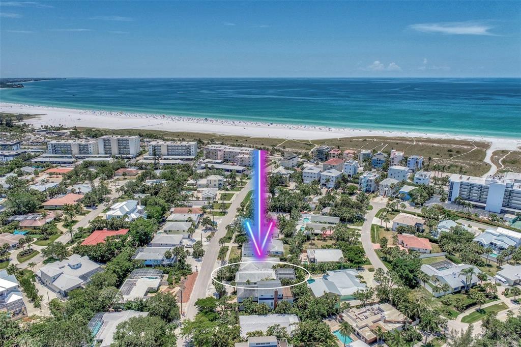 An aerial view shows a residential house circled in white near a sandy beach — 5516 AVENIDA DEL MARE, SARASOTA, FL