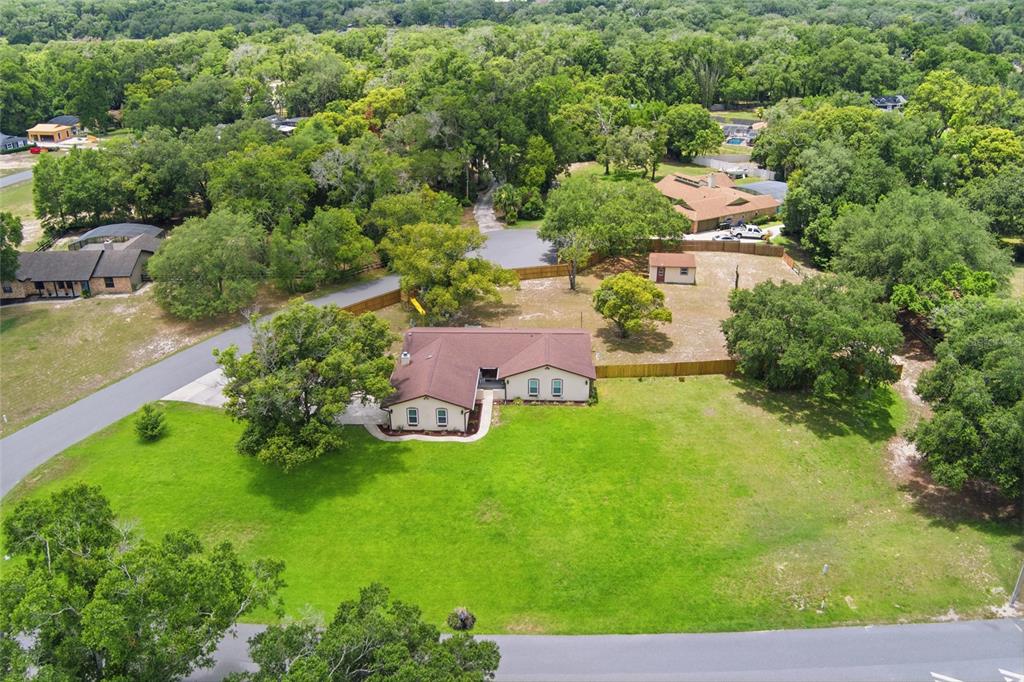 An aerial view shows a single-story house with a brown roof on a large lot — 6538 NIGHTWIND CIRCLE, ORLANDO, FL