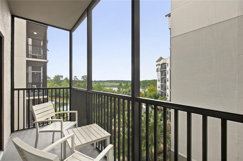 An aerial view of a large multi-story apartment complex surrounded by trees and ponds — 14501 GROVE RESORT AVENUE UNIT 1527, WINTER GARDEN, FL