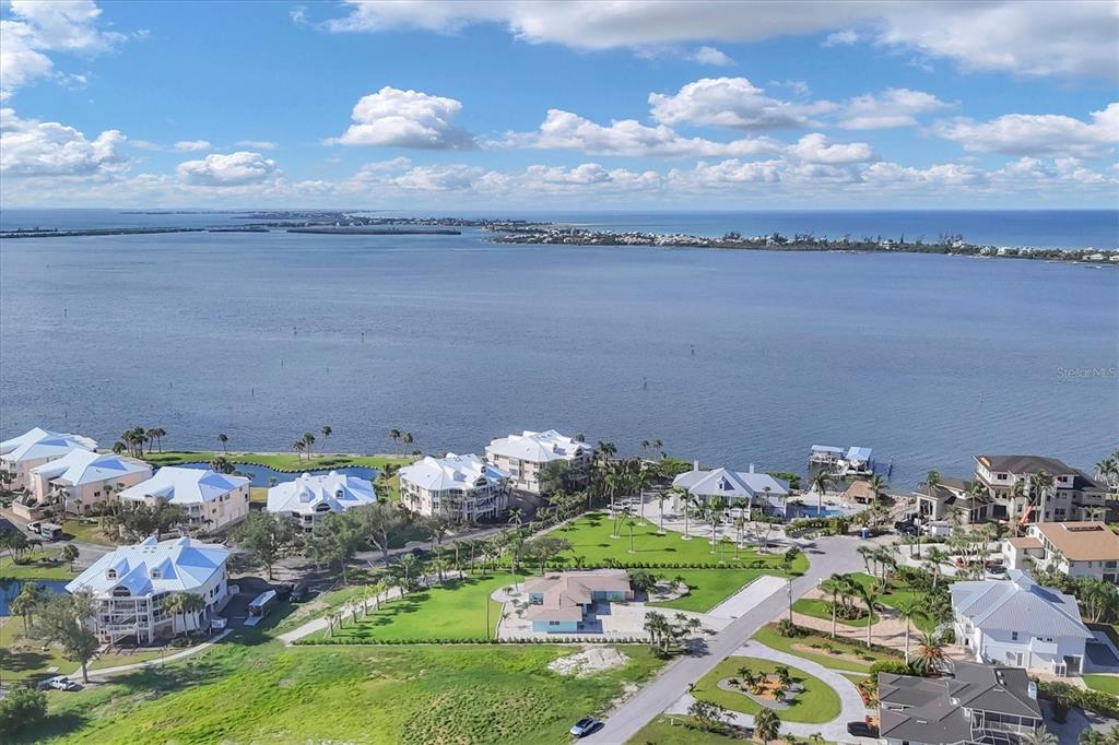 An aerial view of waterfront homes with white roofs situated along a large bay — 550 GASPAR DRIVE, PLACIDA, FL