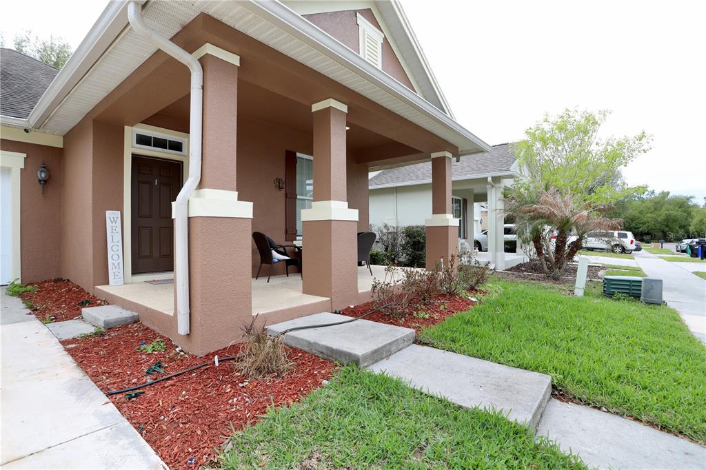 A brown house with a covered front porch, columns, and a concrete walkway — 13622 DARCHANCE ROAD, WINDERMERE, FL