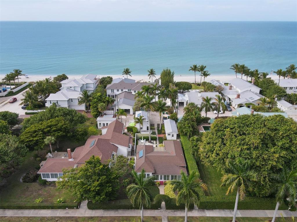 An aerial view of a coastal residential property with multiple houses, palm trees, and beach — 241 GILCHRIST AVENUE UNIT C, BOCA GRANDE, FL