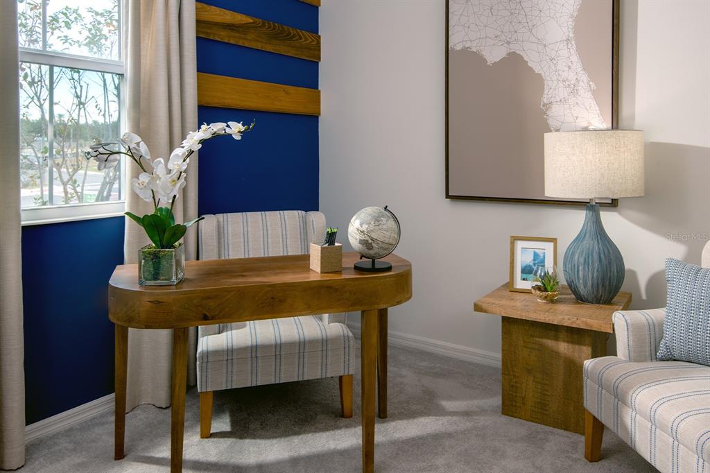 A home office features a wooden desk, a striped chair, and a blue accent wall — 1544 SILVER LINING WAY, APOPKA, FL