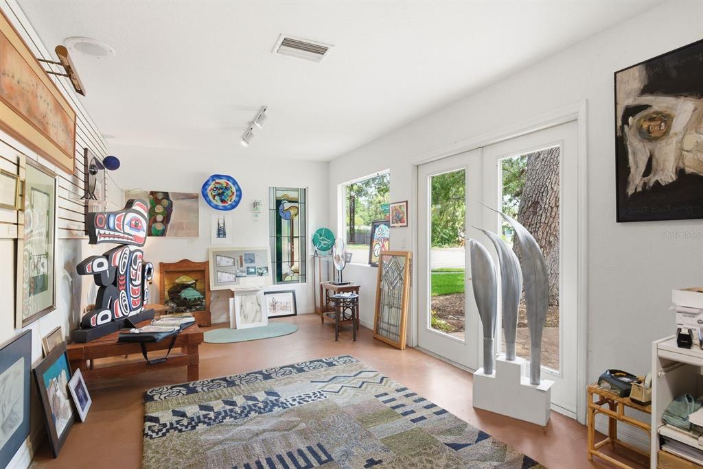 An entryway with tile flooring, a stained-glass front door, and a view into another room — 755 SAN CHRISTOPHER DRIVE, DUNEDIN, FL