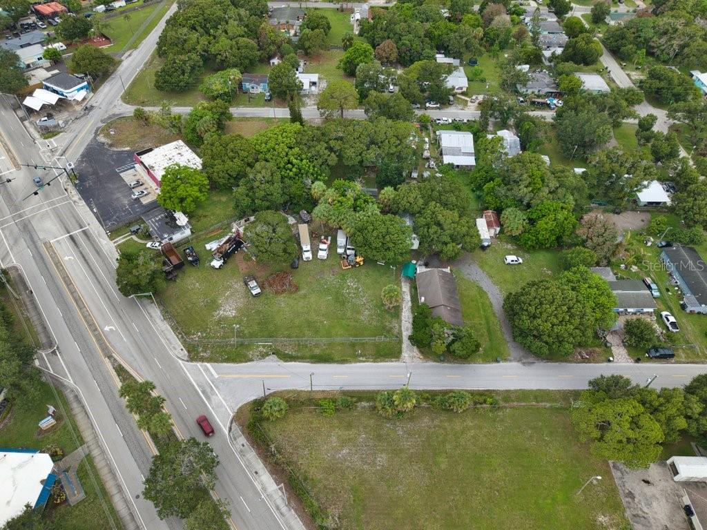 An aerial view shows a residential property with a house, several vehicles, and mature trees — 711 S 21ST STREET, FORT PIERCE, FL