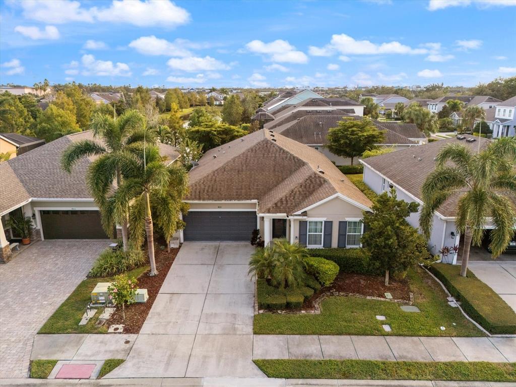 An aerial view shows a suburban house with a brown roof, garage, and palm trees — 805 MOLLY, SARASOTA, FL