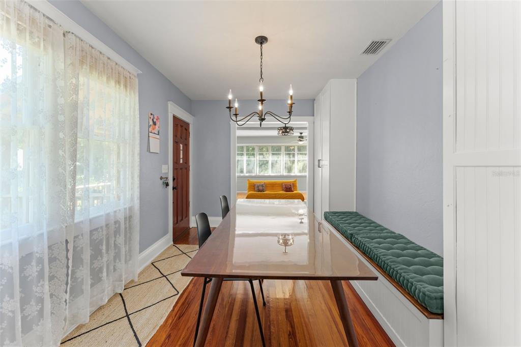A dining area with a wooden table, bench seating, and a view into the kitchen — 1018 S ELM AVENUE, SANFORD, FL