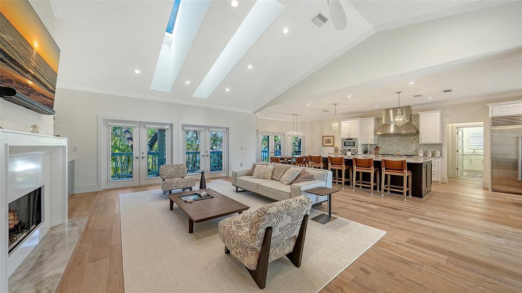 A backyard swimming pool with a fountain, patio furniture, and a two-story white house — 345 MADISON DRIVE, SARASOTA, FL