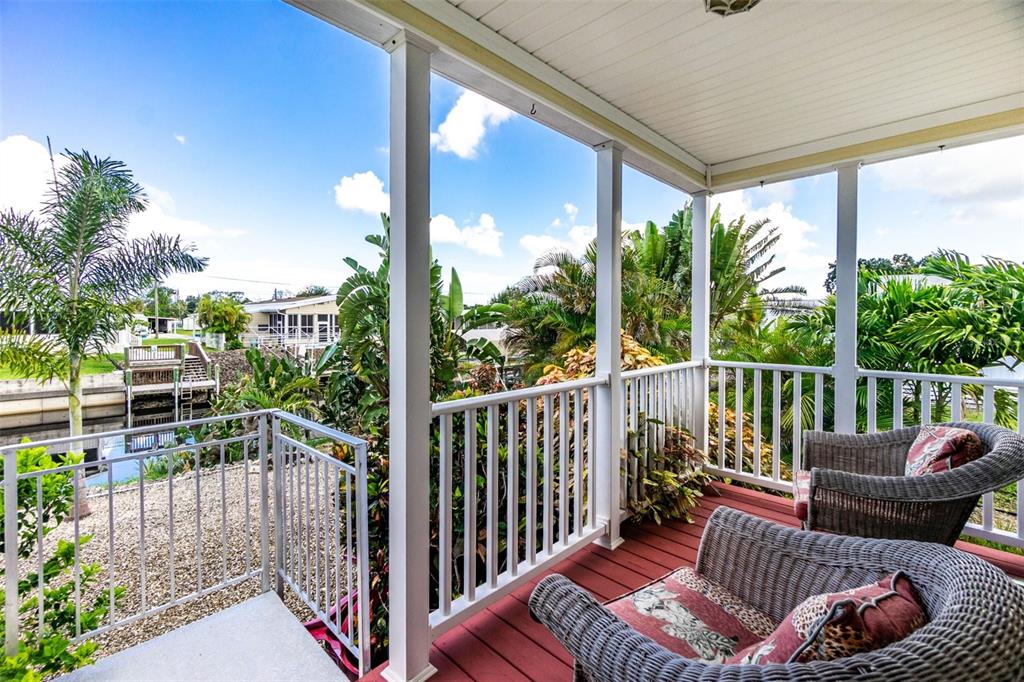 An aerial view shows a manufactured home with a red location pin beside a canal — 1268 SEAGULL DRIVE, ENGLEWOOD, FL
