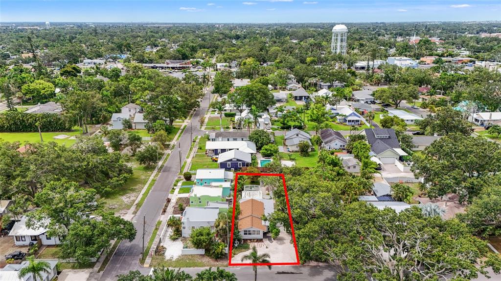 An aerial view shows a single-story house with a brown roof and a red-outlined lot — 2705 2ND AVENUE W, BRADENTON, FL