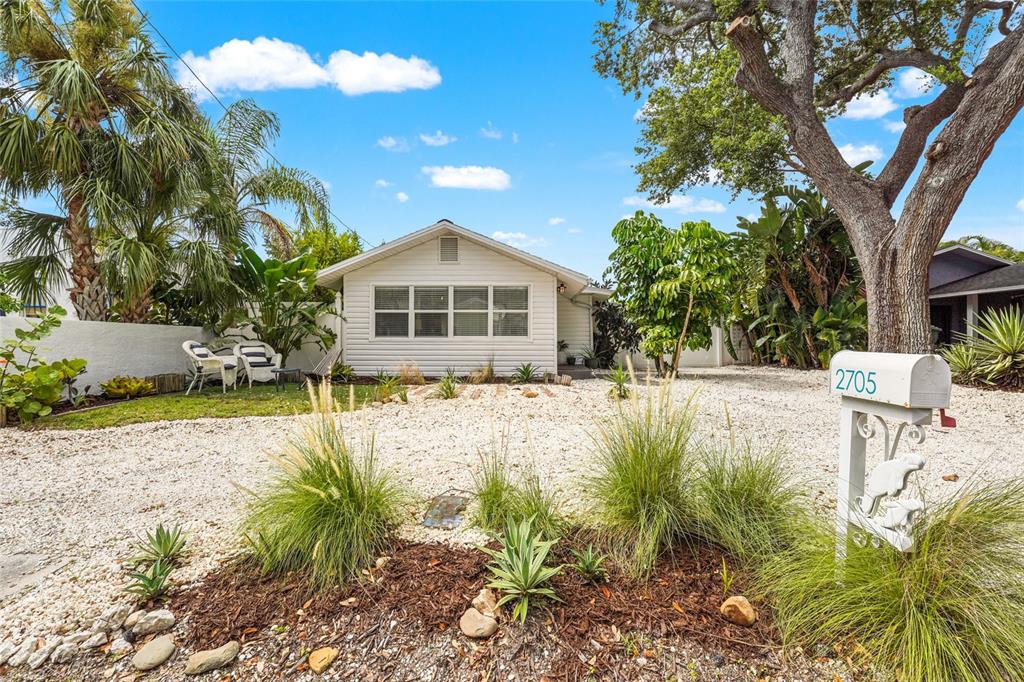 A white, single-story house with a gravel front yard and a decorative mailbox — 2705 2ND AVENUE W, BRADENTON, FL