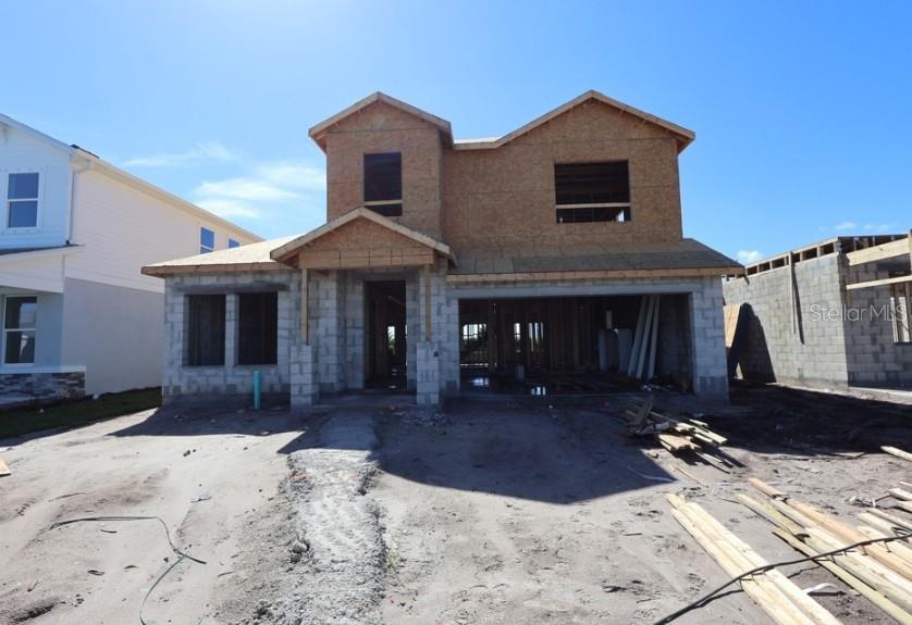 A two-story house under construction with a concrete block base and plywood upper level — 5163 SEA BRANCH AVENUE, APOLLO BEACH, FL