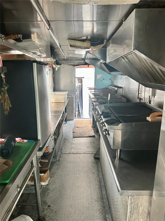 The interior of a food truck features stainless steel kitchen equipment, a grill, and flooring — 6617 N NEBRASKA AVENUE, TAMPA, FL