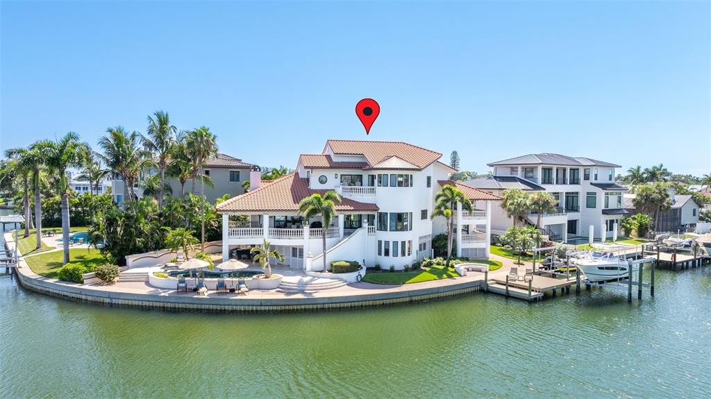 A large waterfront house with a tiled roof, pool, and private boat dock — 101 9TH STREET E, TIERRA VERDE, FL