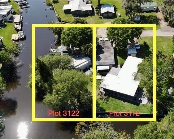Aerial view of two adjacent waterfront properties with houses and boat docks along a canal — 3112 SE 29TH TERRACE, OKEECHOBEE, FL