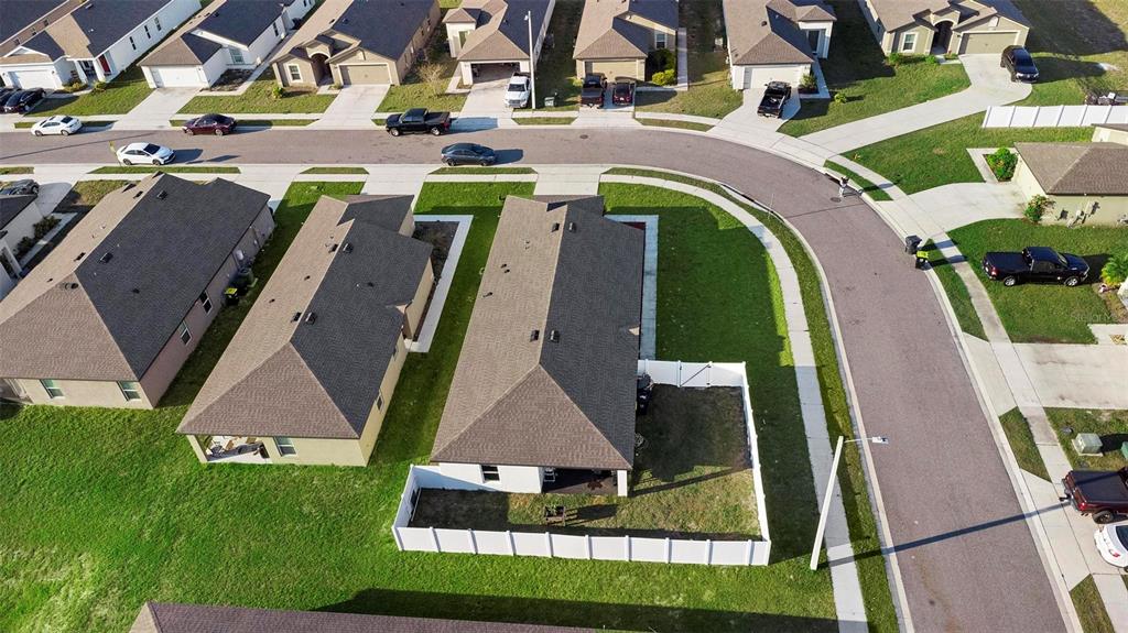 A single-story house exterior features a two-car garage, light-colored stucco walls, and a shingled roof — 440 KENSINGTON VIEW DRIVE, WINTER HAVEN, FL