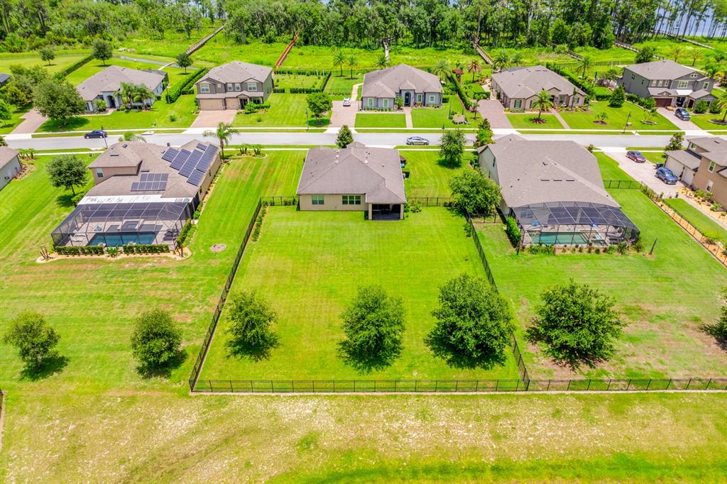 An aerial view shows a suburban neighborhood with houses, a large lake, and a pond — 17590 SAILFIN DRIVE, ORLANDO, FL