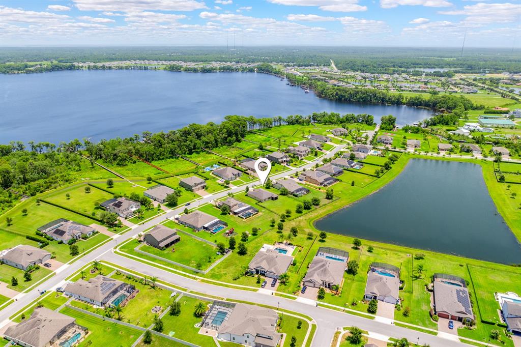 An aerial view of a single-story suburban house with a paved driveway and green lawn — 17590 SAILFIN DRIVE, ORLANDO, FL