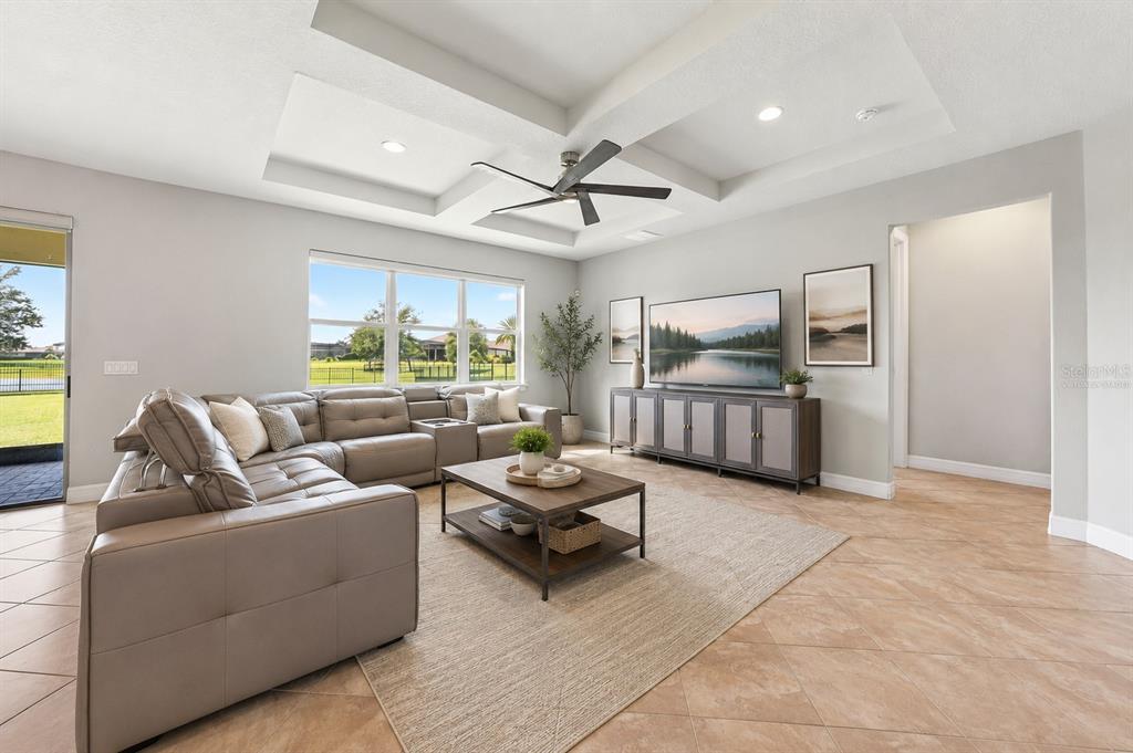 An entryway features a wooden console table, a round mirror, and tile flooring — 17590 SAILFIN DRIVE, ORLANDO, FL