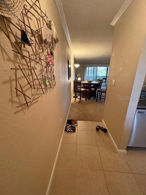 A tiled hallway leads to a dining area with a table and chairs — 10160 SAILWINDS BOULEVARD S UNIT 206, LARGO, FL