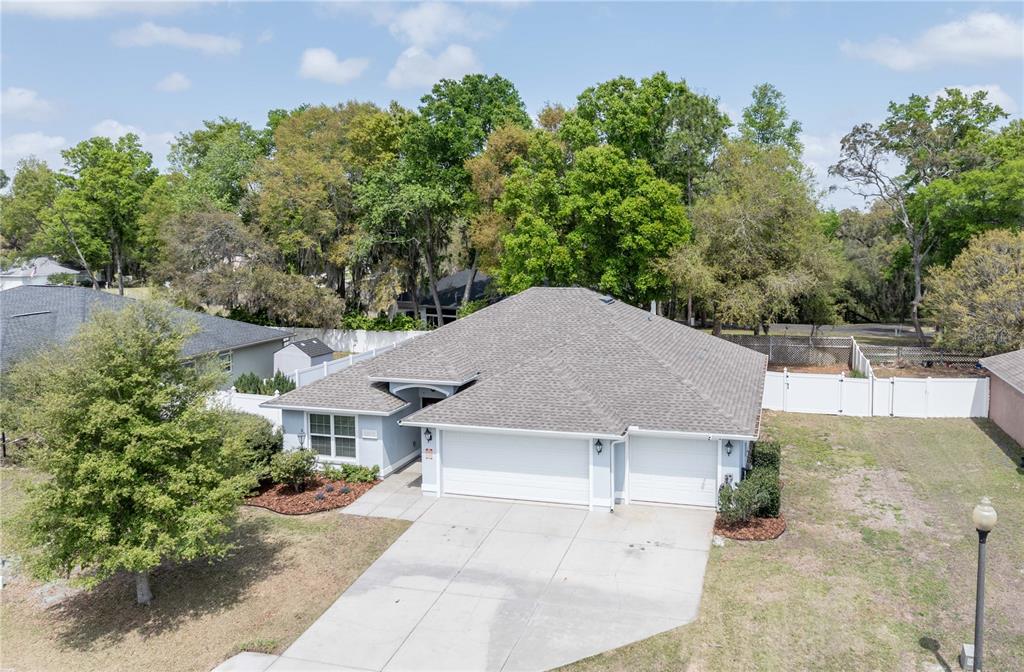 An aerial view shows a single-story house with a gray roof and a two-car garage — 5273 SW 96TH PLACE, OCALA, FL