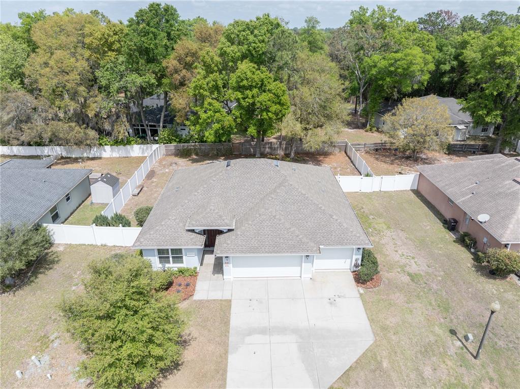 An aerial view shows a single-story house with a gray roof and a concrete driveway — 5273 SW 96TH PLACE, OCALA, FL