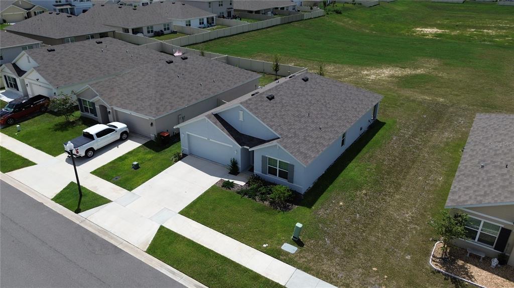 An aerial view shows a light blue single-story house with a driveway and attached garage — 4728 SW 85TH PLACE, OCALA, FL