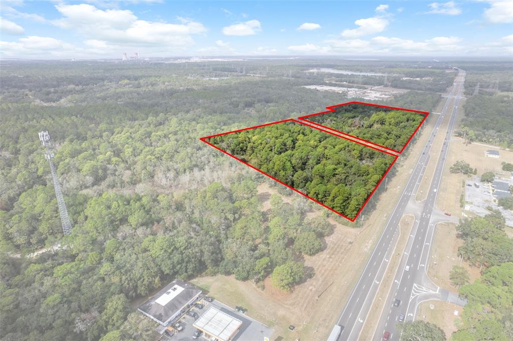 An aerial view shows two adjacent wooded lots outlined in red next to a highway — 11621 W GARNET COURT, CRYSTAL RIVER, FL