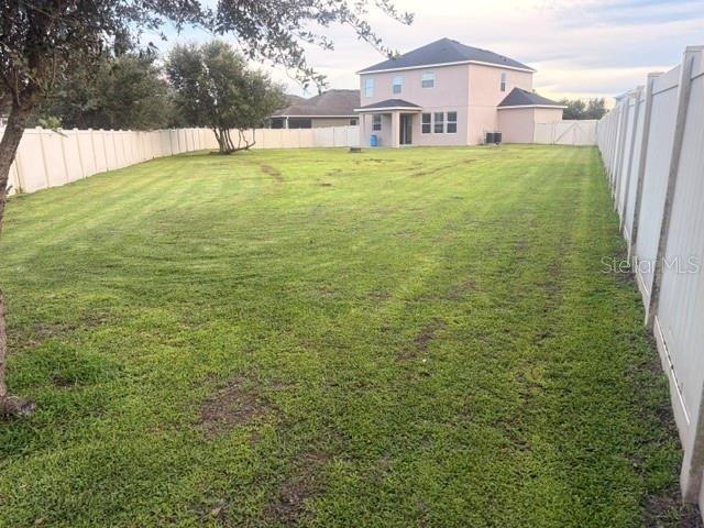 A two-story suburban house with a gray exterior, blue shutters, and a two-car garage — 3504 BLITHE COURT, ST CLOUD, FL