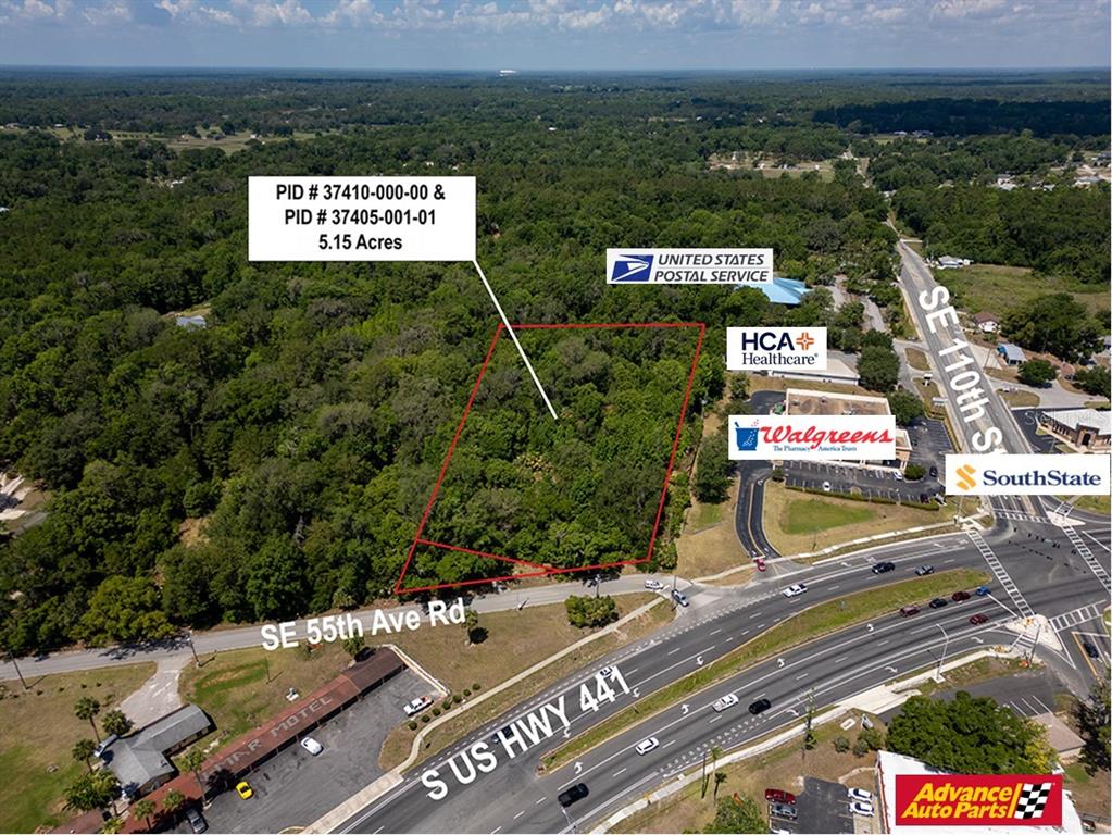 An aerial view shows a wooded plot of land outlined in red near a highway — 11144 SE 55TH AVENUE ROAD, BELLEVIEW, FL