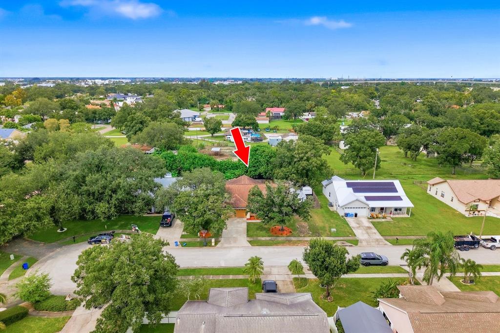 A single-story house with a tan stucco exterior, arched entryway, and a two-car garage — 5955 107TH TERRACE N, PINELLAS PARK, FL