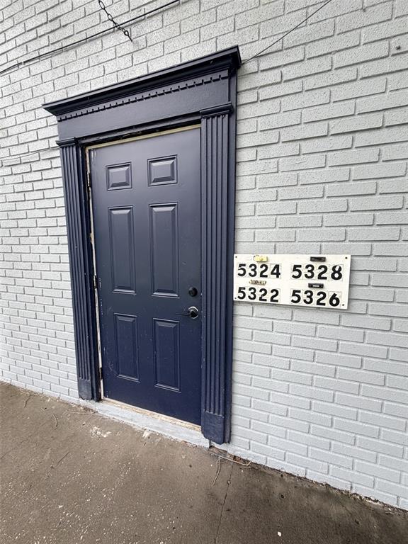 A dark blue door with a decorative frame sits beside a wall-mounted mailbox unit — 5328 WHITEWAY DRIVE, TEMPLE TERRACE, FL