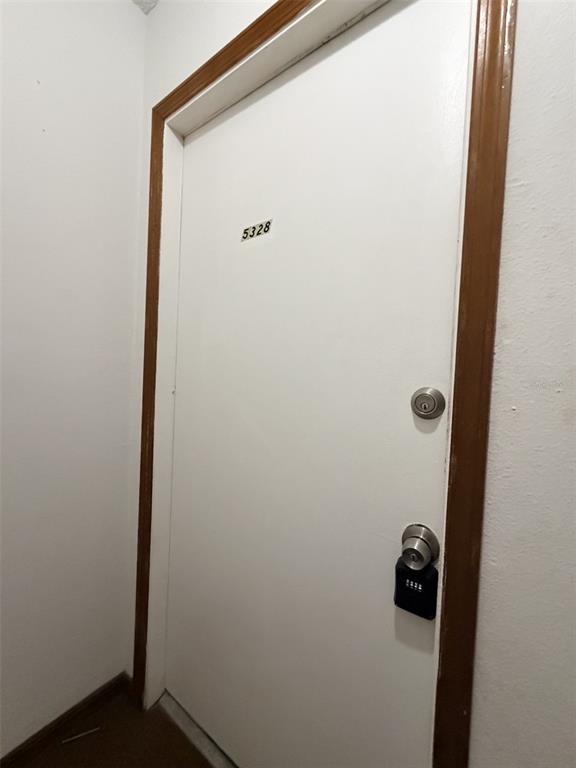 A white apartment door with the number 5328 and a black lockbox on the handle — 5328 WHITEWAY DRIVE, TEMPLE TERRACE, FL