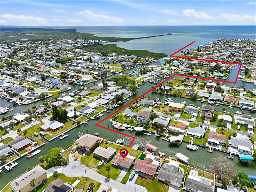 This is an aerial view of a waterfront residential neighborhood with a highlighted property — 13603 BRITTON DRIVE, HUDSON, FL