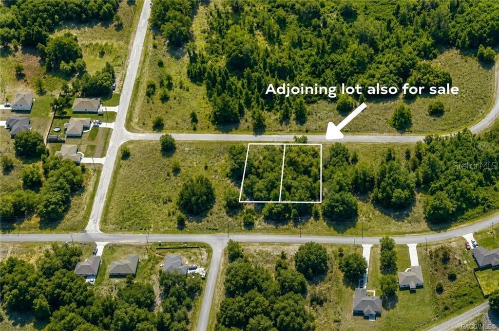 An aerial view shows two adjacent vacant lots outlined in white within a residential neighborhood — 7622 N FISHER TERRACE, CITRUS SPRINGS, FL