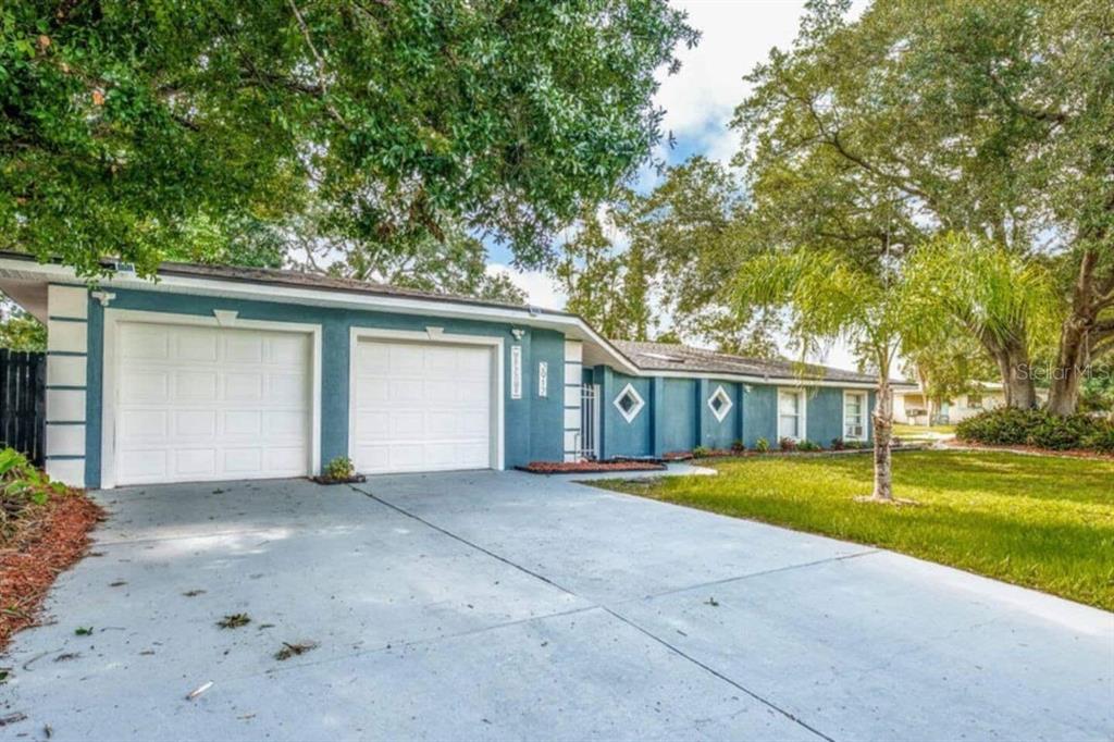 A blue single-story house with a two-car garage and a concrete driveway — 2917 STETSON STREET, MELBOURNE, FL