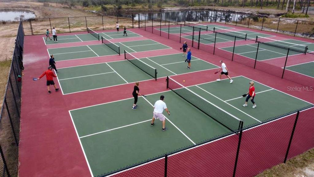 An aerial view shows several pickleball courts with players in an outdoor recreational area — 96 CR-630 E, LAKE WALES, FL