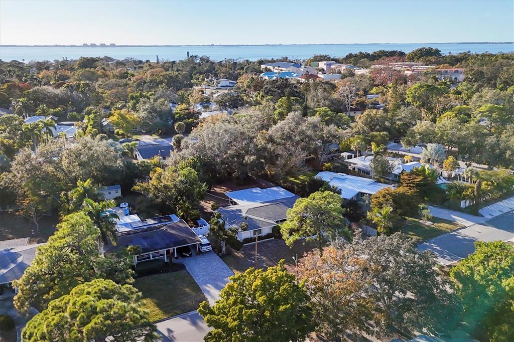 A room with gray walls, carpeted flooring, a built-in white bookshelf, and a wooden desk — 5201 STEVENS DRIVE, SARASOTA, FL