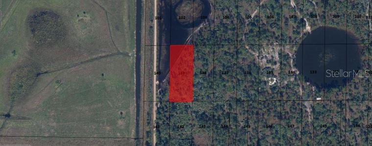 An aerial map view shows a rectangular red-highlighted parcel of land next to a road — N/A, INDIANTOWN, FL