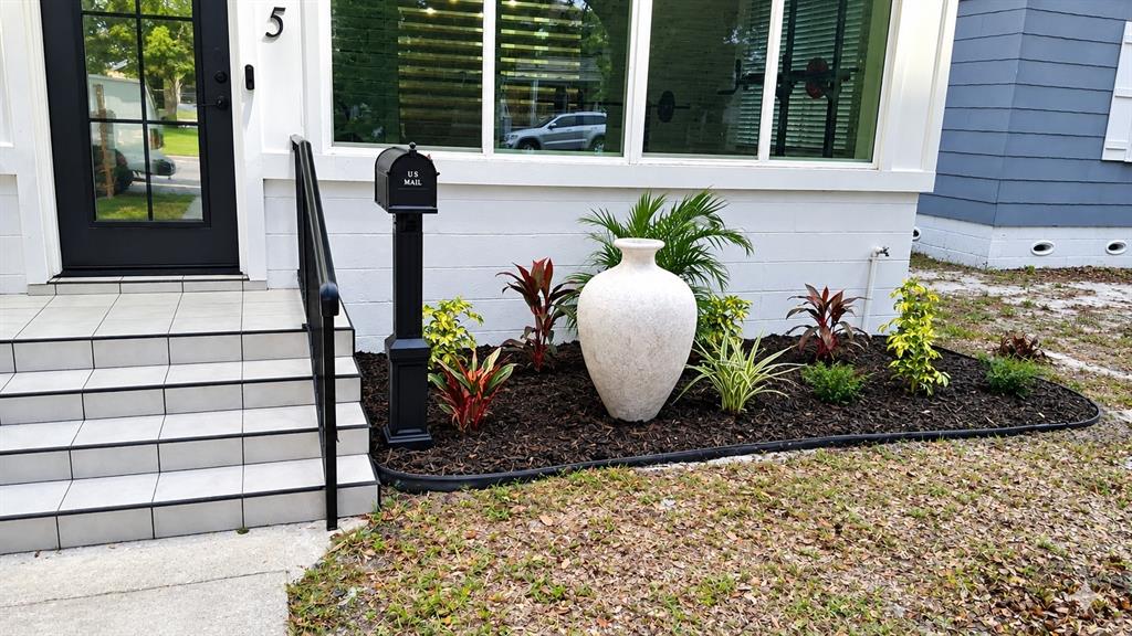 A single-story white house with a black front door and a large front window — 3745 1ST AVENUE N, ST PETERSBURG, FL