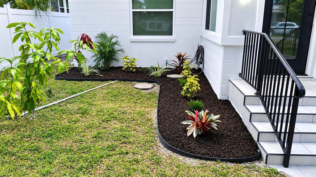 A white, single-story house with a black front door and a small concrete porch — 3745 1ST AVENUE N, ST PETERSBURG, FL