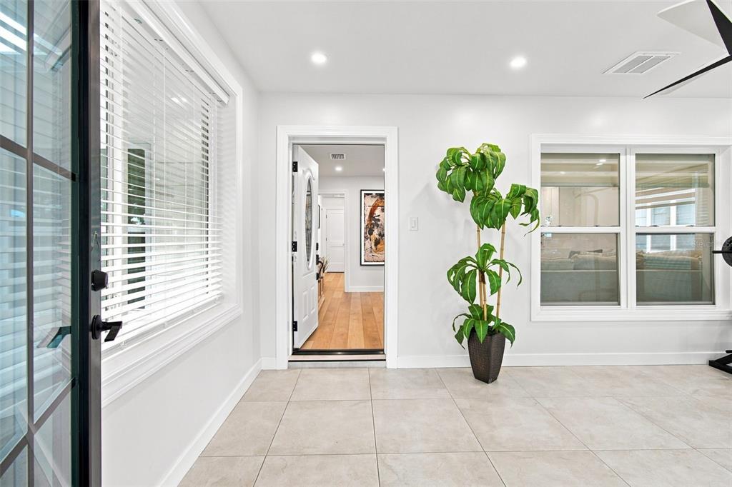 A white, single-story house with a large front window and a small porch with stairs — 3745 1ST AVENUE N, ST PETERSBURG, FL