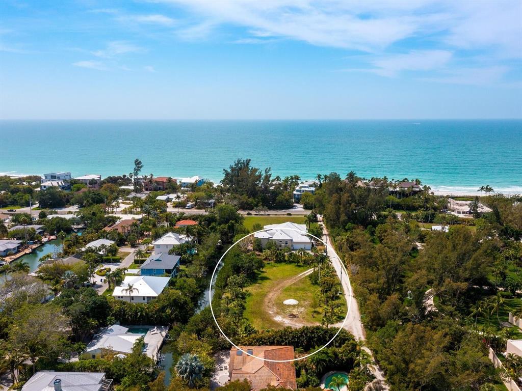 An aerial view shows a large, undeveloped lot circled in white near a coastal beach — 6604-6608 GULF OF MEXICO DRIVE, LONGBOAT KEY, FL