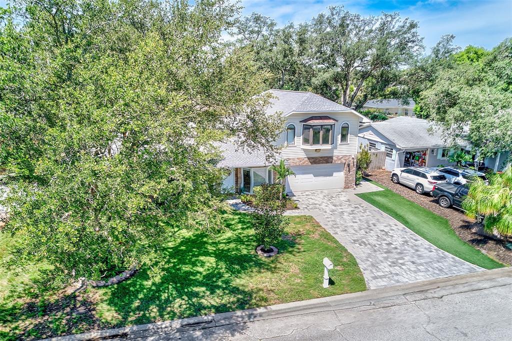 An aerial view of a two-story house with a paved driveway and a large front yard — 812 WILLOWBRANCH AVENUE, CLEARWATER, FL
