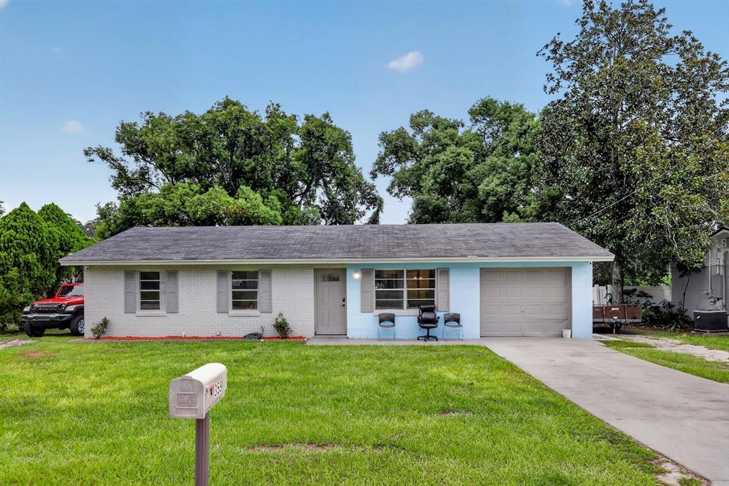 A single-story house with a light blue and white brick exterior and a concrete driveway — 359 W LANSDOWNE AVENUE, ORANGE CITY, FL