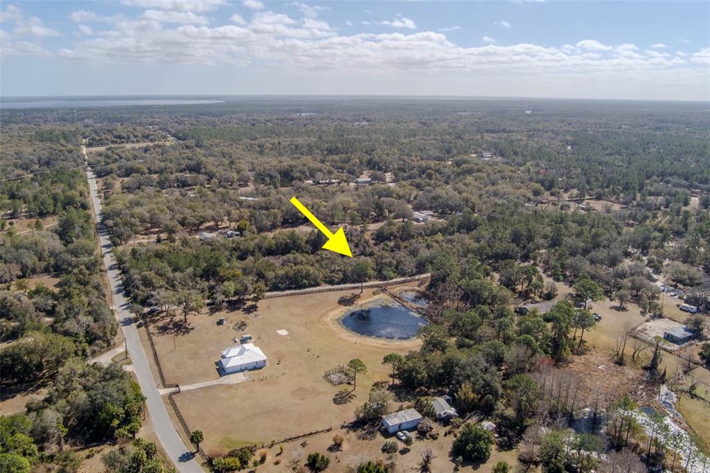 An aerial view shows a rural property with a house, a pond, and surrounding woods — COCHRAN ROAD, GENEVA, FL