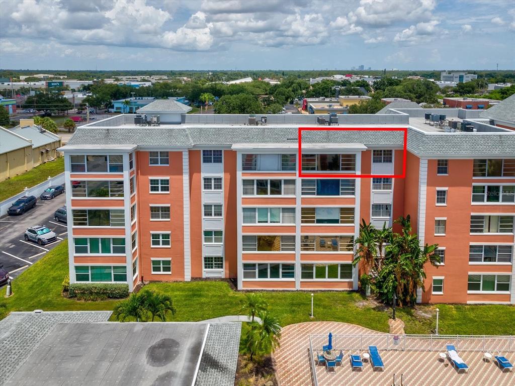 A white door marked 503 is set into a peach-colored exterior wall along a walkway — 6800 20TH AVENUE N UNIT 503, ST PETERSBURG, FL