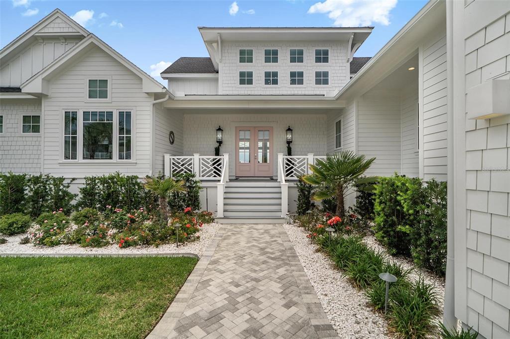 A white house with a pink double front door and a stone walkway — 8065 A1A S, ST AUGUSTINE, FL