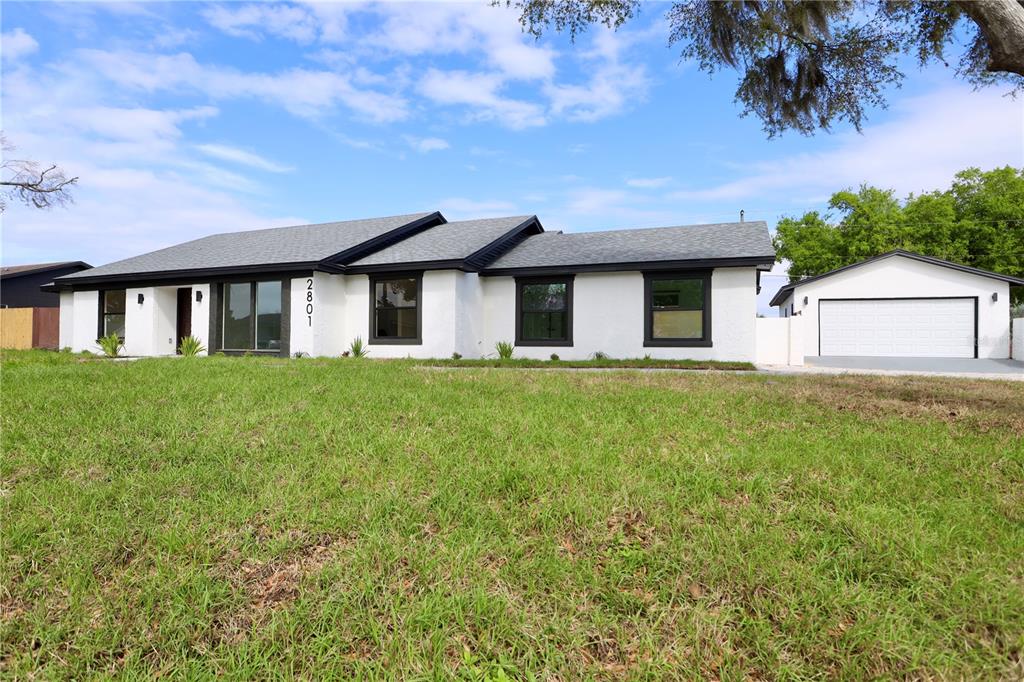 An aerial view shows a house with a gray shingled roof and paved driveway — 2801 WAUMPI TRAIL, MAITLAND, FL